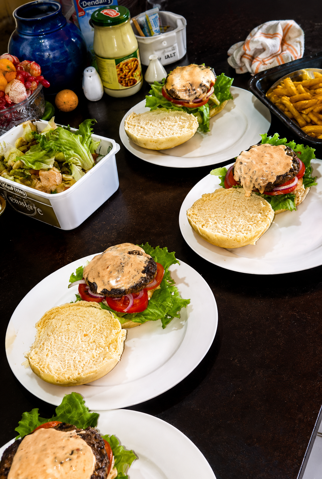 Prepared burgers with salad and fries in the Stonehouse kitchen